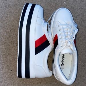 Platform white sneakers with red and black stripes